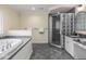 Bright bathroom with a tub, shower and stone countertops at 1207 Pickwick Pl, Indianapolis, IN 46208
