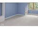Cozy bedroom featuring natural light, neutral carpet, and painted blue walls at 1207 Pickwick Pl, Indianapolis, IN 46208