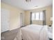 Well-lit bedroom featuring a neutral decor and a large window at 1207 Pickwick Pl, Indianapolis, IN 46208