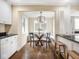 Charming dining area featuring a built-in bench, stylish light fixture, and hardwood flooring at 1207 Pickwick Pl, Indianapolis, IN 46208
