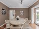 Stylish dining room featuring hardwood floors, contemporary decor, and a neutral color scheme at 1207 Pickwick Pl, Indianapolis, IN 46208