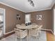 Dining room features modern lighting, seating for six, and easy access to other rooms at 1207 Pickwick Pl, Indianapolis, IN 46208