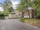 Driveway view showing the back of the home and side structure at 1207 Pickwick Pl, Indianapolis, IN 46208