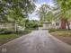 Long driveway leading to home with side structures and landscaping at 1207 Pickwick Pl, Indianapolis, IN 46208