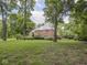 Two-story brick home with a lush green lawn surrounded by mature trees at 1207 Pickwick Pl, Indianapolis, IN 46208