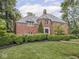 Beautiful brick two-story home with a meticulously manicured front yard and lush landscaping at 1207 Pickwick Pl, Indianapolis, IN 46208