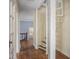 Hallway with wooden floors, a white spiral staircase, and access to a bedroom at 1207 Pickwick Pl, Indianapolis, IN 46208