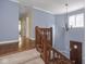 Hallway and staircase featuring classic design with wooden banisters and hardwood floors at 1207 Pickwick Pl, Indianapolis, IN 46208