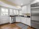 Modern kitchen with white cabinets, stainless steel appliances, and hardwood floors at 1207 Pickwick Pl, Indianapolis, IN 46208