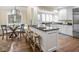 Bright kitchen featuring an island, white cabinetry, and dining nook with lots of natural light at 1207 Pickwick Pl, Indianapolis, IN 46208