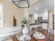 Open kitchen with white cabinets, black countertops, and a dining area with built-in seating at 1207 Pickwick Pl, Indianapolis, IN 46208