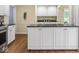 Modern kitchen featuring hardwood floors, stainless steel appliances and white cabinets at 1207 Pickwick Pl, Indianapolis, IN 46208