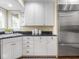 Modern kitchen with stainless steel appliances, white cabinets, and hardwood floors at 1207 Pickwick Pl, Indianapolis, IN 46208
