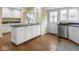 Modern kitchen featuring an island with stool seating, stainless steel appliances, and hardwood floors at 1207 Pickwick Pl, Indianapolis, IN 46208