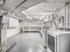 Bright basement laundry room with washer, dryer, storage, and utility sink at 1207 Pickwick Pl, Indianapolis, IN 46208