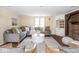 Bright living room with modern furniture, brick fireplace, and ample natural light at 1207 Pickwick Pl, Indianapolis, IN 46208