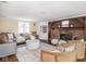 Spacious living room with a brick fireplace, comfortable seating, and stylish decor at 1207 Pickwick Pl, Indianapolis, IN 46208