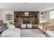 Inviting living room featuring a brick fireplace, built-in shelving, and modern decor at 1207 Pickwick Pl, Indianapolis, IN 46208