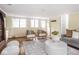 Bright living room with modern furnishings, decorative fireplace, and natural light from large windows at 1207 Pickwick Pl, Indianapolis, IN 46208