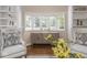 Comfortable living room showcasing a large bay window, built-in shelving, and neutral decor at 1207 Pickwick Pl, Indianapolis, IN 46208