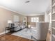 Bright living room features hardwood floors, a decorative rug, and built-in shelving for displaying decor at 1207 Pickwick Pl, Indianapolis, IN 46208