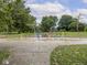 View of the playground, which has a splash pad, climbing equipment, and swings at 1207 Pickwick Pl, Indianapolis, IN 46208