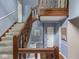 Staircase with wooden banister leads to upper level, complemented by neutral walls and flooring at 1207 Pickwick Pl, Indianapolis, IN 46208