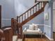 Staircase with wooden banister in a neutrally decorated home at 1207 Pickwick Pl, Indianapolis, IN 46208