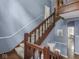 Classic staircase with wood banister, carpeted steps, and access to multiple levels at 1207 Pickwick Pl, Indianapolis, IN 46208