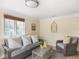 Inviting sunroom with a wicker seating, a neutral color palette, and lots of natural light at 1207 Pickwick Pl, Indianapolis, IN 46208