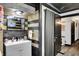 Stylish bathroom featuring a modern vanity, mirror, unique light fixture, and decorative wood accent wall at 121 Ursal Ln, Greenwood, IN 46143