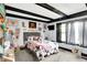 Well-lit bedroom features decorative items, ceiling beam accents, carpet floors, and a large window at 121 Ursal Ln, Greenwood, IN 46143