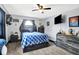 Bedroom featuring carpet floors, ceiling fan, closet, and a large TV for entertainment at 121 Ursal Ln, Greenwood, IN 46143