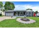 Charming one-story home with a grey exterior, covered porch and landscaped front yard at 121 Ursal Ln, Greenwood, IN 46143