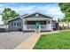 Charming one-story home with a grey exterior, inviting covered front porch and walkway at 121 Ursal Ln, Greenwood, IN 46143