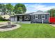 Charming one-story home with a grey exterior, covered porch and landscaped front yard at 121 Ursal Ln, Greenwood, IN 46143