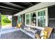 Cozy front porch with seating area, stylish rug, and charming curb appeal at 121 Ursal Ln, Greenwood, IN 46143