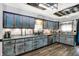 Kitchen with stone countertops, stainless steel appliances, and blue cabinets with wooden accents at 121 Ursal Ln, Greenwood, IN 46143
