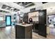 Open concept kitchen with stainless steel appliances, center island, and adjacent laundry room at 121 Ursal Ln, Greenwood, IN 46143