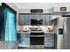 Updated kitchen features stainless steel appliances, gas range and oven, and blue cabinetry with wooden accents at 121 Ursal Ln, Greenwood, IN 46143