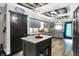 Spacious kitchen featuring an island, stylish light fixtures, and trendy blue cabinetry with wooden accents at 121 Ursal Ln, Greenwood, IN 46143