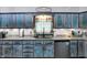 Kitchen features stone countertops, stainless steel appliances, and blue cabinets with wooden accents at 121 Ursal Ln, Greenwood, IN 46143