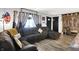 Comfortable living room with a large sectional couch, wood-look floors, and rustic decor at 121 Ursal Ln, Greenwood, IN 46143