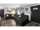 Comfortable living room with a large sectional couch, wood-look floors, and ample natural light at 121 Ursal Ln, Greenwood, IN 46143