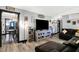 Open-concept living room with wood-look floors, modern decor and access to dining area at 121 Ursal Ln, Greenwood, IN 46143