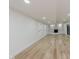 Finished basement with wood-look flooring, stone fireplace, and walk-out sliding doors at 12118 Castle Row Overlook, Carmel, IN 46033