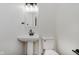 Sleek bathroom featuring a pedestal sink, modern fixtures, and a pristine white toilet at 12118 Castle Row Overlook, Carmel, IN 46033