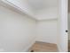 Empty closet with white walls, wooden floor, and a white hanging rod at 12118 Castle Row Overlook, Carmel, IN 46033