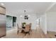Dining room with glass table and four rattan chairs at 12118 Castle Row Overlook, Carmel, IN 46033