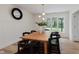 Bright dining area features a stylish light fixture, wood table, and wainscoting at 12118 Castle Row Overlook, Carmel, IN 46033